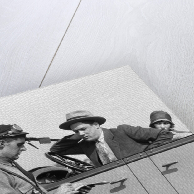 1920s Motorcycle Policeman Writing A Speeding Ticket To A Couple Sitting In Convertible Sedan by Anonymous