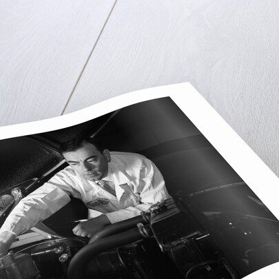 1950s Man Automotive Mechanic Servicing Car Engine by Anonymous