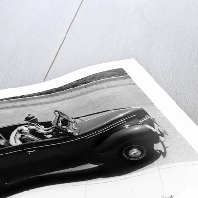 1930s 1940s Couple Driving 1938 Convertible Four Door Sedan Automobile With Luggage In Back Seat by Anonymous