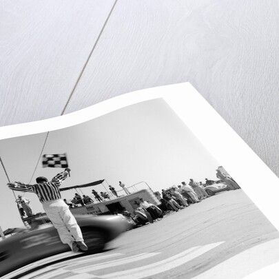 1960s Man Jumping Waving Checkered Flag As Winning Sports Car Crossing The Finish Line by Anonymous