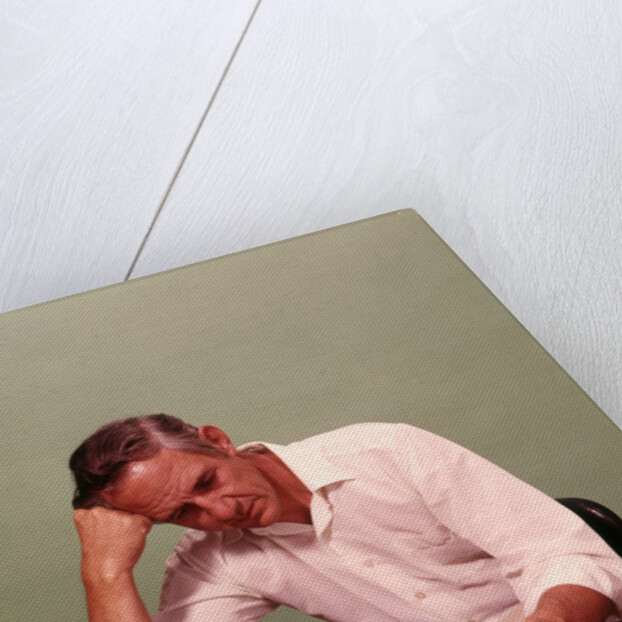 1970s Middle Age Man Sitting At Desk Worried About Bills To Pay by Anonymous