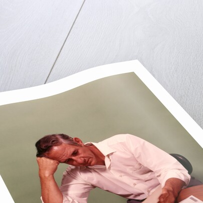 1970s Middle Age Man Sitting At Desk Worried About Bills To Pay by Anonymous