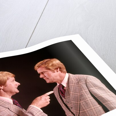 1970s Angry Red Haired Man In Plaid Suit Arguing With Himself by Anonymous