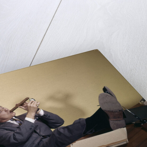 1960s Successful Businessman With Look Of Satisfaction Sitting With Shoes Propped On Desk by Anonymous