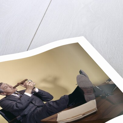 1960s Successful Businessman With Look Of Satisfaction Sitting With Shoes Propped On Desk by Anonymous