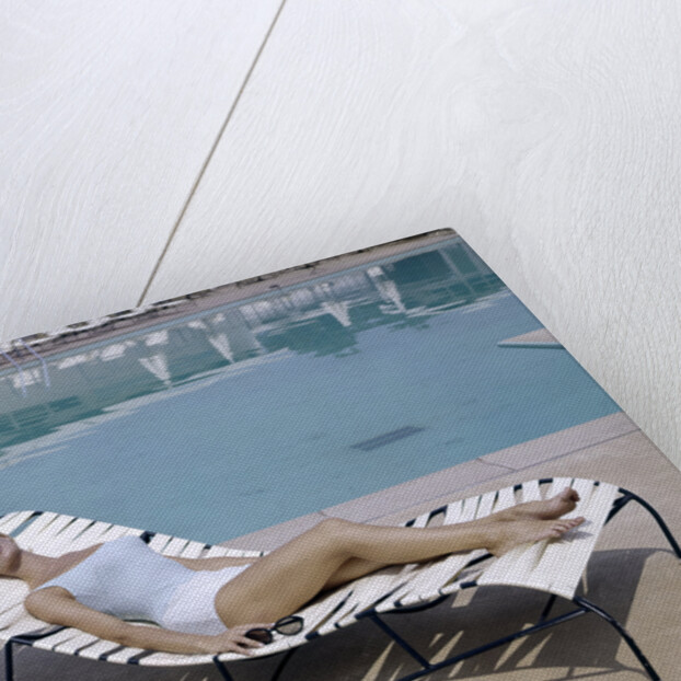 1960s Elegant Tall Woman In Bathing Suit Reclining On A Lounge Chair By Swimming Pool by Anonymous