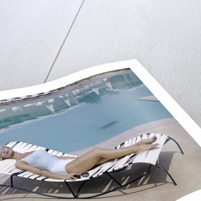 1960s Elegant Tall Woman In Bathing Suit Reclining On A Lounge Chair By Swimming Pool by Anonymous