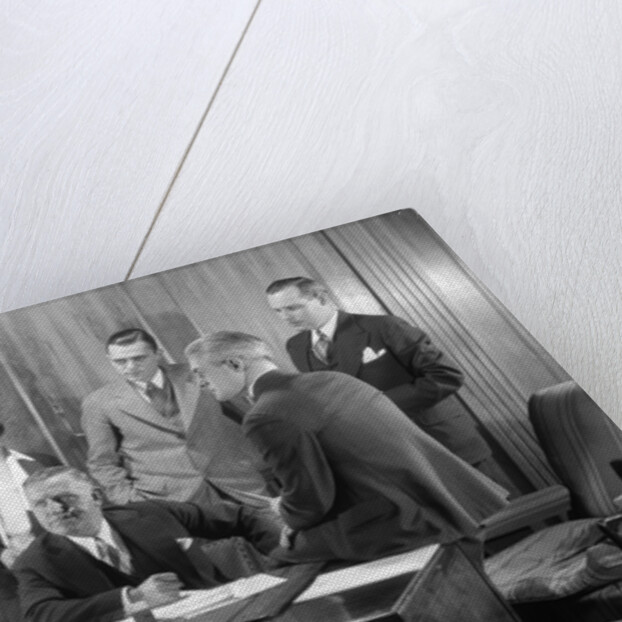 1930s Worried Business Group In Office Meeting Around The Boss' Desk by Anonymous
