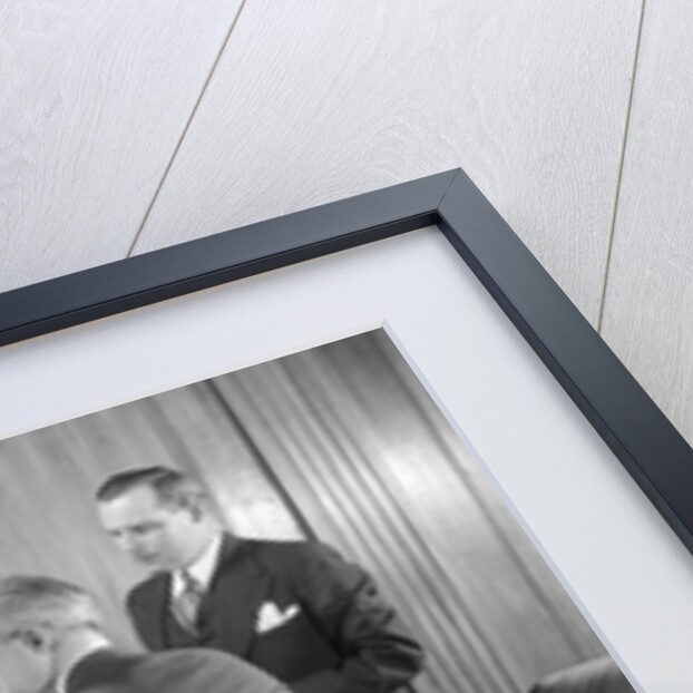 1930s Worried Business Group In Office Meeting Around The Boss' Desk by Anonymous