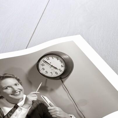 1950s Woman Holding Steno Pad Pointing With Pencil To Clock 5 Minutes Till Quitting Time by Anonymous