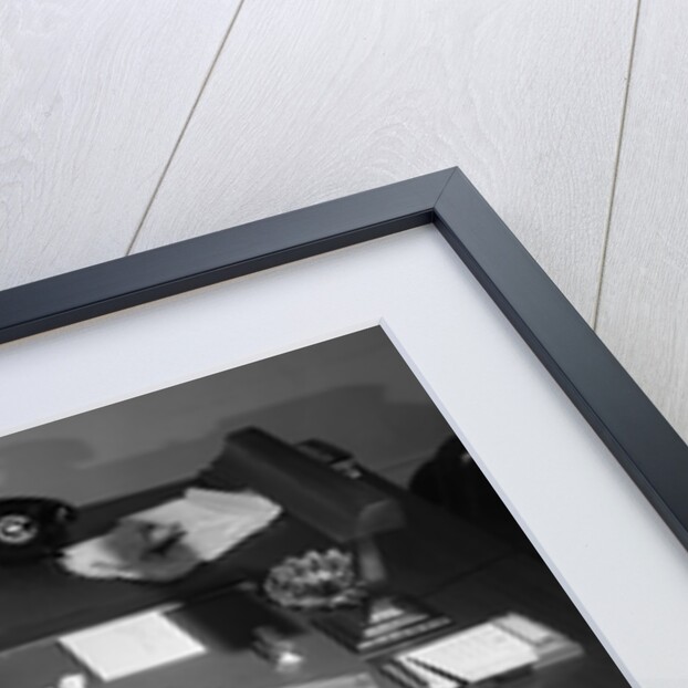 1950s Man Businessman Salesman Eating Lunch In Office With Feet Resting Up On Desk by Anonymous