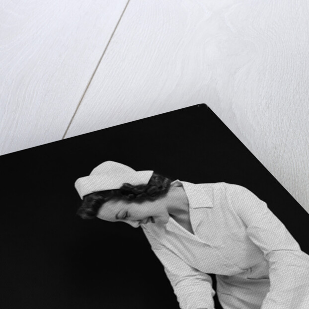 1940s Woman Nurse Changing Baby Diaper In Nursery by Anonymous