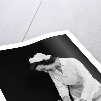 1940s Woman Nurse Changing Baby Diaper In Nursery by Anonymous