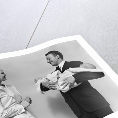 1930s 1940s Woman Nurse Talking With Man Proud New Father Holding Newborn Twin Babies by Anonymous