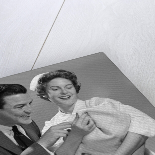 1950s 1960s Man New Father Looking At Baby Held By Woman Nurse by Anonymous