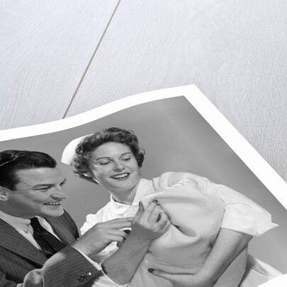 1950s 1960s Man New Father Looking At Baby Held By Woman Nurse by Anonymous