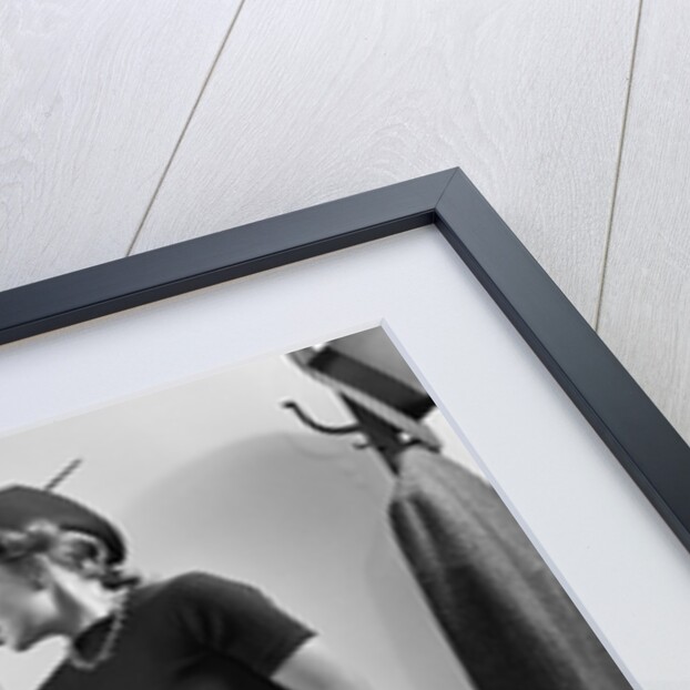 1940s Woman Sitting On Desk Hat Skirt Hand Gesture Talking Flirting With Man by Anonymous