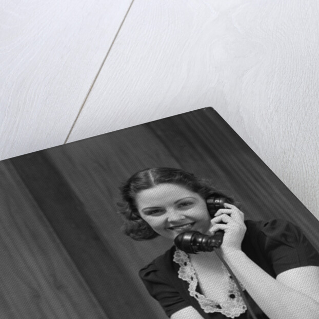 1930s Woman Receptionist Secretary Sitting At Desk In Office Talking On Telephone by Anonymous