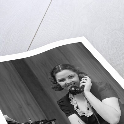 1930s Woman Receptionist Secretary Sitting At Desk In Office Talking On Telephone by Anonymous