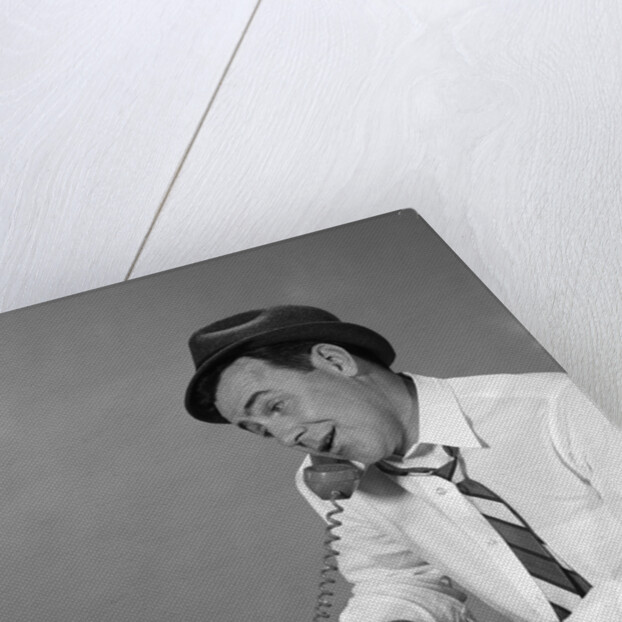 1960s Reporter With Hat On Phone At Typewriter by Anonymous