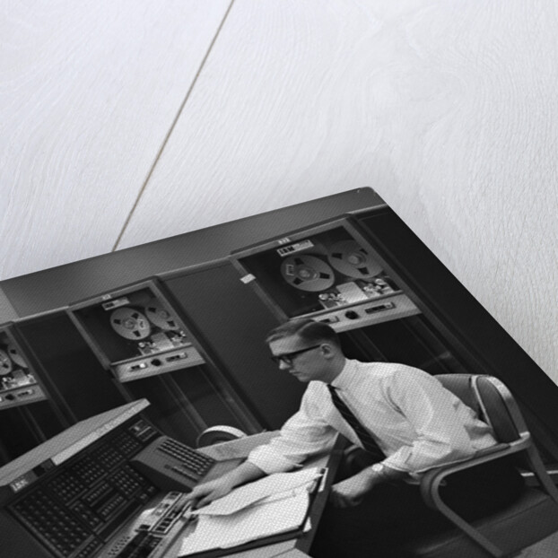 1960s Man In Shirt Tie and Thick Black Glasses Working With IBM Data Processing System by Anonymous