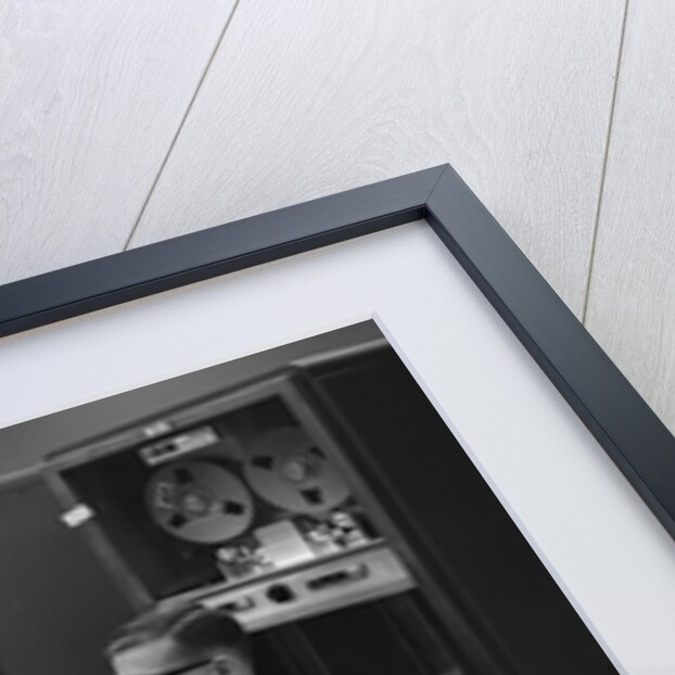 1960s Man In Shirt Tie and Thick Black Glasses Working With IBM Data Processing System by Anonymous