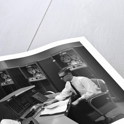 1960s Man In Shirt Tie and Thick Black Glasses Working With IBM Data Processing System by Anonymous