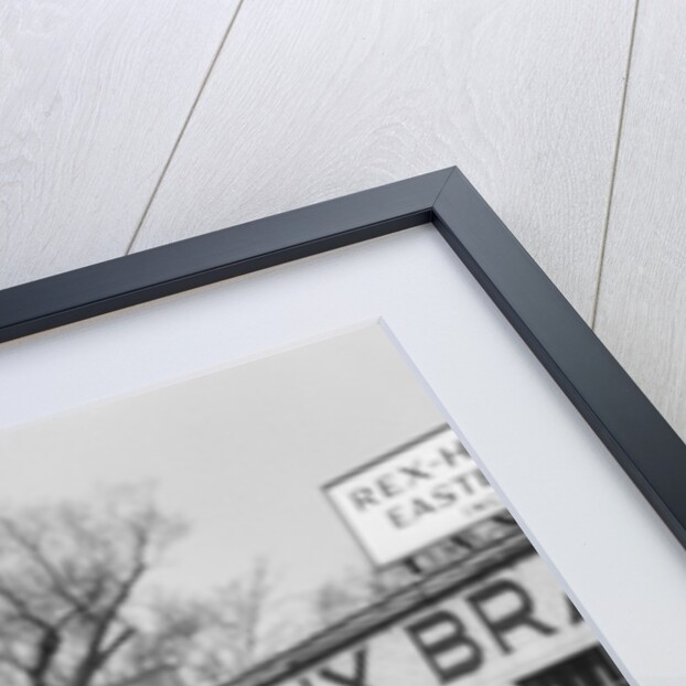 1930s Service Station Attendant In Cap and Coveralls Pouring Water From Spouted Can Into Automobile Radiator by Anonymous