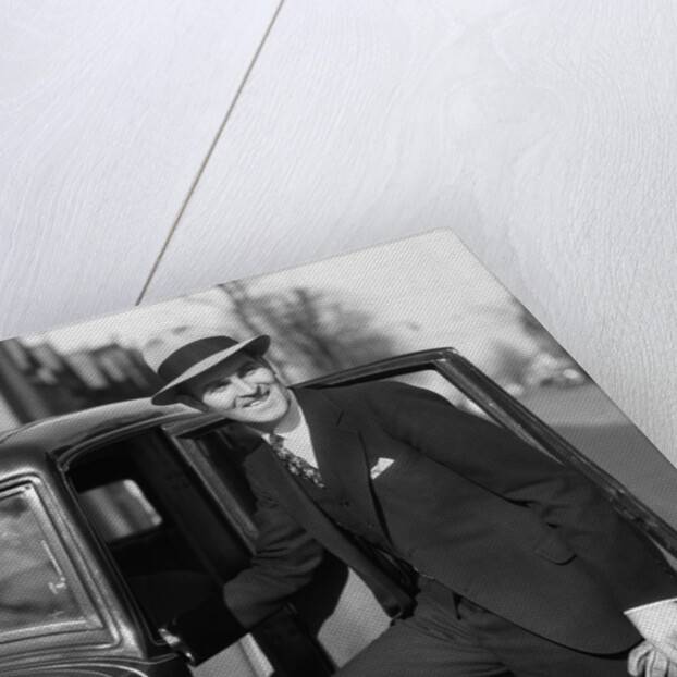 1930s Man In Suit And Hat Holding Gloves Stepping Into Automobile Driver Seat by Anonymous