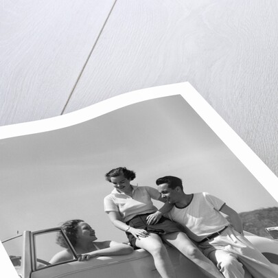 1930s Friends Sitting With Convertible Roadster Automobile Talking Together At Seashore by Anonymous