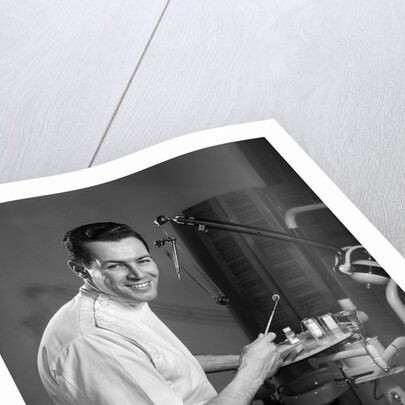 1960s Portrait Man Professional Dentist Holding Dental Tool Mirror by Anonymous