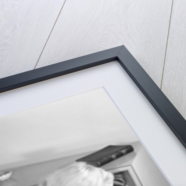 1960s Little Girl Turning On Television Set by Anonymous