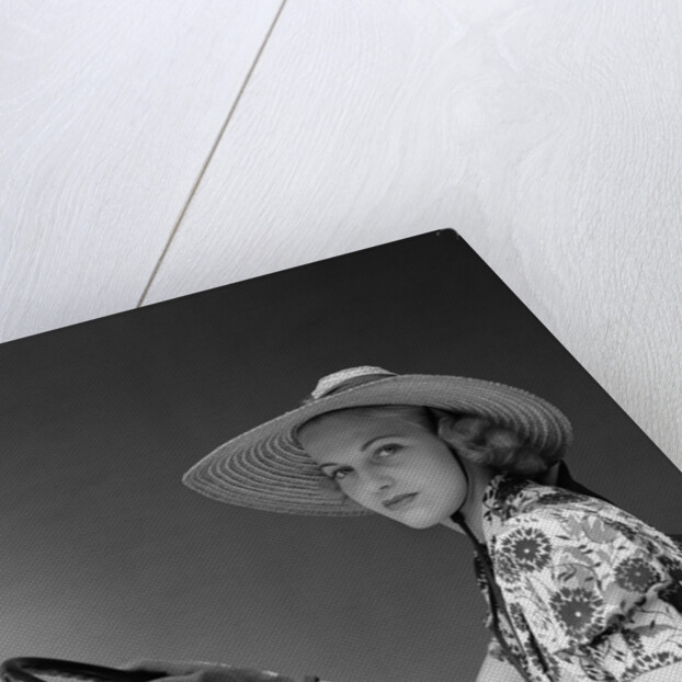 1930s 1940s Woman Wearing Straw Hat Sun Dress Driving Gloves Holding Auto Mobile Steering Wheel Looking At Camera by Anonymous