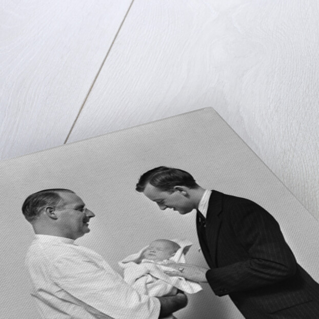 1930s 1940s Man Doctor Showing New Born Infant Baby To Proud Father by Anonymous