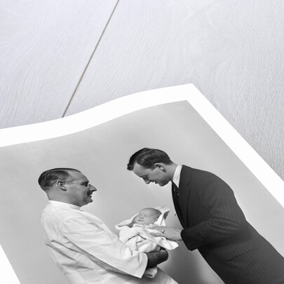 1930s 1940s Man Doctor Showing New Born Infant Baby To Proud Father by Anonymous