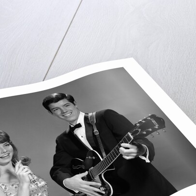 1960s Teenage Entertainment Duo Man Playing Guitar And Woman Singing Holding Microphone by Anonymous