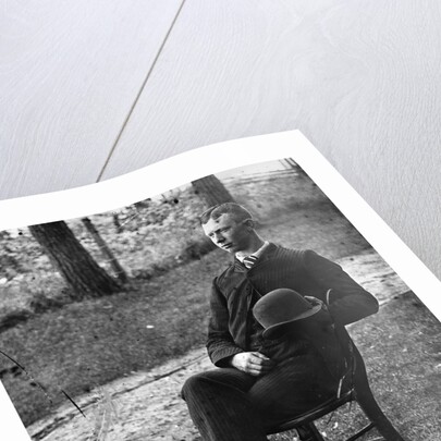 1890s 1900s Side View Of Man Wearing Suit Seated On Chair Outside Holding Bowler Hat by Anonymous