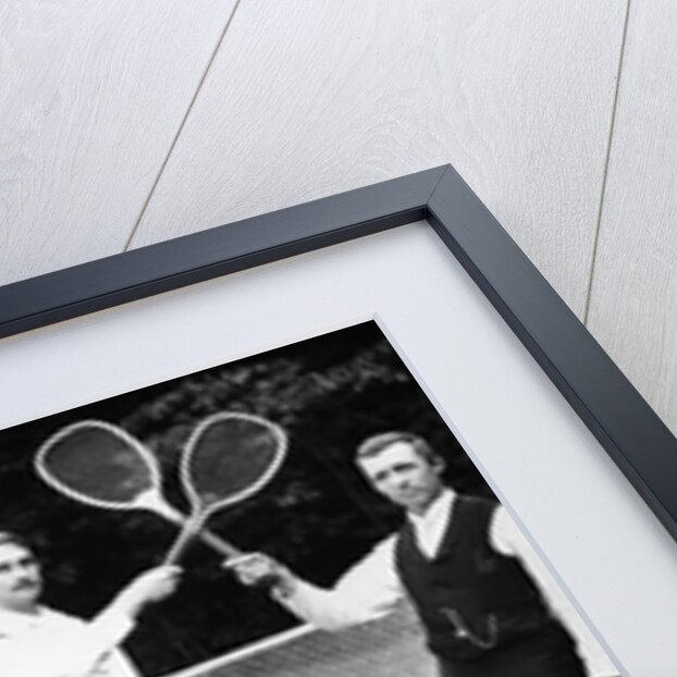 1890s 1900 Men Holding Racquets and Women and One Child In Front Of Net On Grass Tennis Court by Anonymous