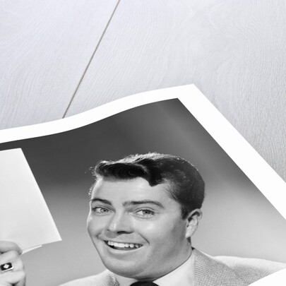 1950s Young Businessman Holding Up Handful Of Papers by Anonymous