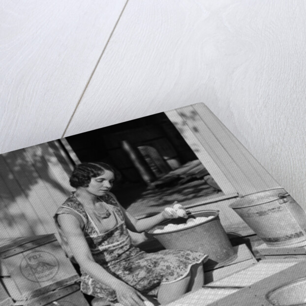 1930s Woman Farm Wife Sitting Outside Of Hen House Doorway Putting Eggs From Pails Into Shipping Crates by Anonymous