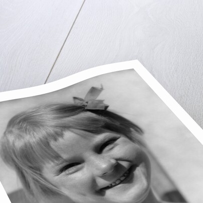 1930s Young Girl Outdoor Portrait With Freckles And Bow In Hair At Camera by Anonymous