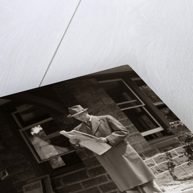 1950s Businessman On Railroad Station Platform Reading Newspaper Waiting For Train by Anonymous