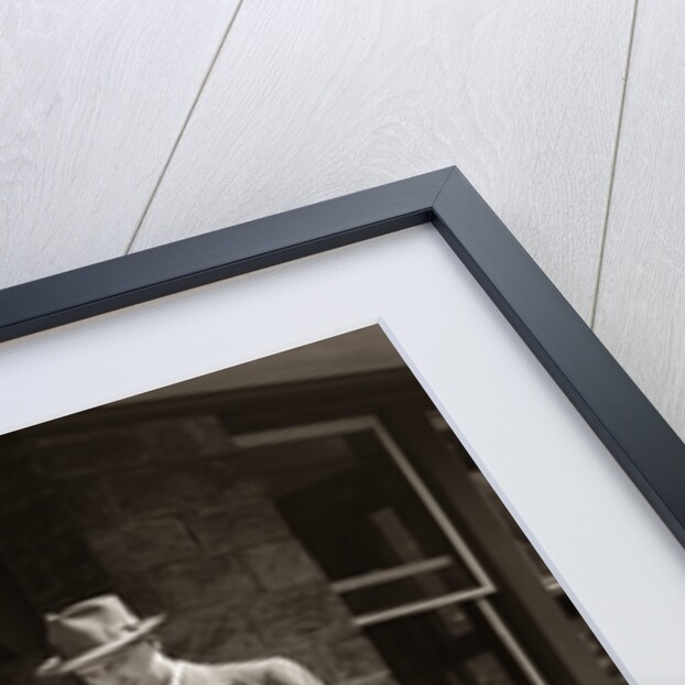 1950s Businessman On Railroad Station Platform Reading Newspaper Waiting For Train by Anonymous