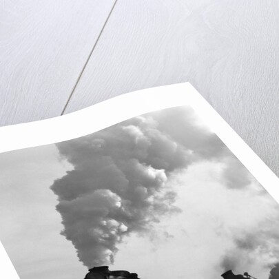 1930s 1940s Head-On View Of Three Steam Engines Silhouetted Against Billowing Smoke And Steam Outdoor by Anonymous