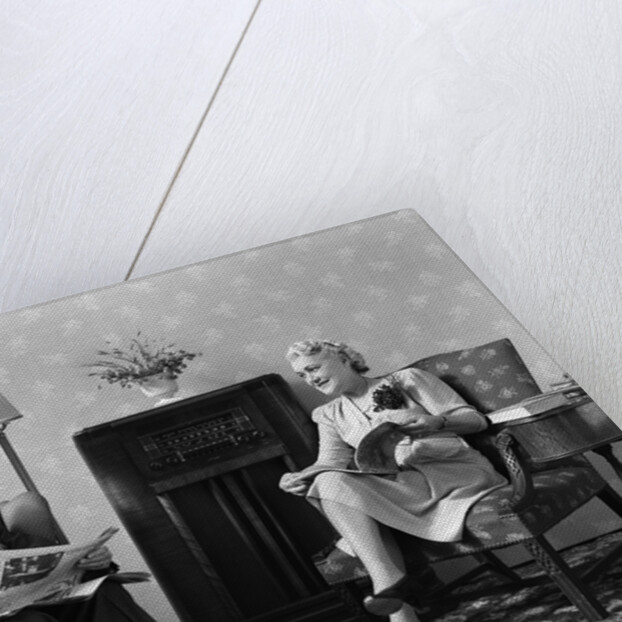 1940s Senior Couple Sitting In Living Room Reading Newspaper And Magazine Listening To Radio by Anonymous