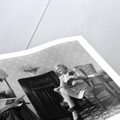 1940s Senior Couple Sitting In Living Room Reading Newspaper And Magazine Listening To Radio by Anonymous