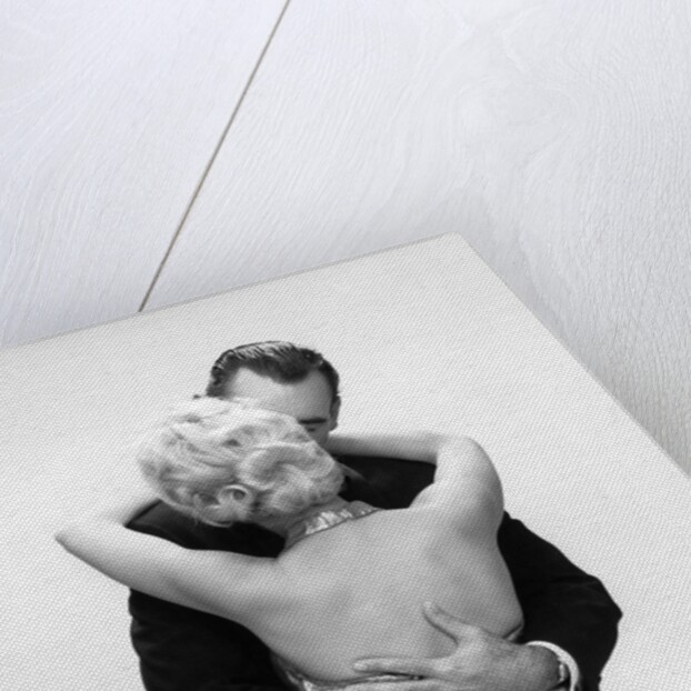 1950s 1960s Wife In Backless Satin Gown Evening Dress And Husband Embracing And Kissing by Anonymous