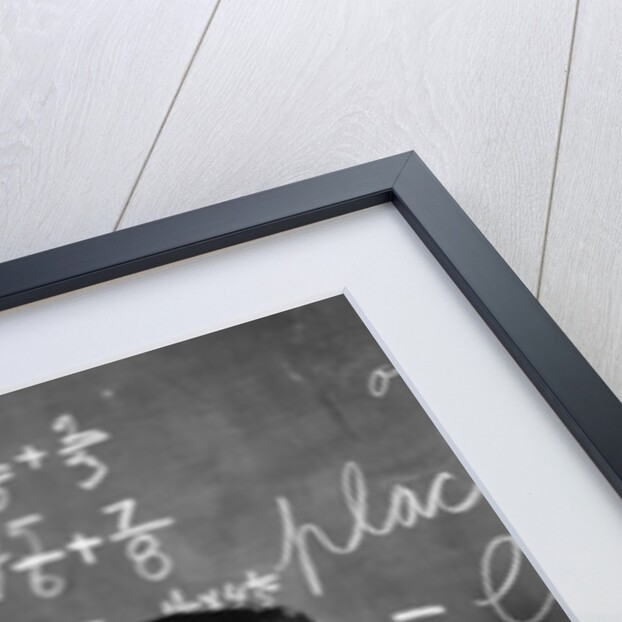 1920s 1930s Boy At Desk In Classroom In Front Of Blackboard Shooting Paper Wad With Rubber Band by Anonymous