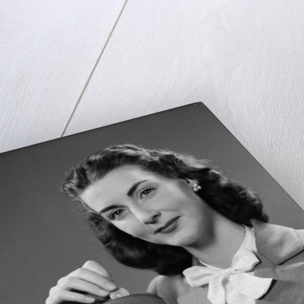 1940s Woman Putting Change Into Piggy Bank by Anonymous