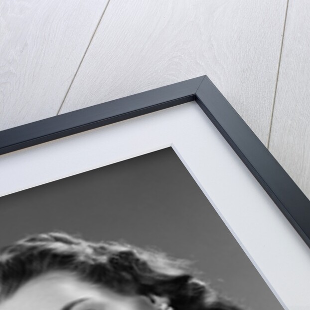 1940s Woman Putting Change Into Piggy Bank by Anonymous